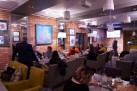 Zdjęcie przedstawia uczestników wydarzenia siedzących w restauracji. 
