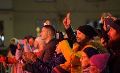 Publiczność, kilka z osób nagrywa odbywający się na scenie występ. 