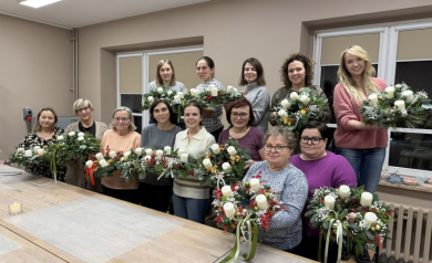 Zdjęcie grupowe osób uczestniczących w warsztatach tworzenia kompozycji adwentowo-bożonarodzeniowych. 